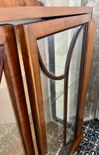 Load image into Gallery viewer, This stunning piece is an antique Art Deco display cabinet, dating from the 1930s. It is characterised by its walnut or mahogany construction, featuring astragal-glazed doors with a distinctive curved pattern and claw-and-ball feet.