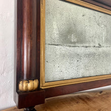 Load image into Gallery viewer, A mid-19th-century rosewood overmantle mirror in landscape form, the frame has classical columns to the sides, and top with gilt collars, and the gilt frame edging has detailed ball feet to create a standout period design.