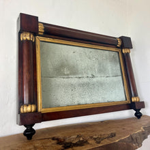 Load image into Gallery viewer, A mid-19th-century rosewood overmantle mirror in landscape form, the frame has classical columns to the sides, and top with gilt collars, and the gilt frame edging has detailed ball feet to create a standout period design.