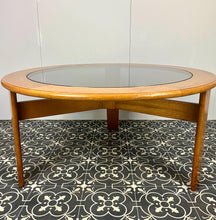 Load image into Gallery viewer, Lovely vintage chic Scandinavian coffee table which comes with an original natural light circular teak colour and smoked glass top, which creates a superb interior design.
