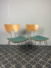 Load image into Gallery viewer, They are introducing a stylish and functional set of chairs from Kusch+Co. The teal blue/green colour adds a touch of retro elegance to any kitchen or dining room. At the same time, the 1970s hairpin legs and atomic-inspired backrests