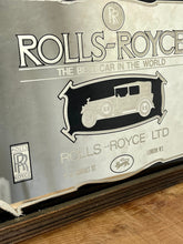 Load image into Gallery viewer, I see an advertisement featuring a sleek silver Rolls Royce car against a black background, complete with the iconic Rolls Royce logo. It looks very elegant and stylish.