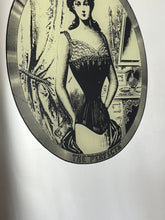 Load image into Gallery viewer, The mirror depicts a glamorous Victorian lady in an oval design with a noir effect, and it includes intricate details and a provocative finish. The walnut frame is of high quality and dates back to the 1920s.