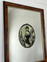 Load image into Gallery viewer, The mirror depicts a glamorous Victorian lady in an oval design with a noir effect, and it includes intricate details and a provocative finish. The walnut frame is of high quality and dates back to the 1920s.