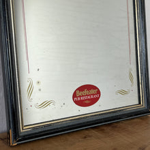 Load image into Gallery viewer, It features an oval logo of the famous pub branding in a matt red, an intricate Victorian-style gold border, and a darker wooden frame.