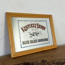 Load image into Gallery viewer, features a horse racing design. The branding is depicted in bold, vivid fonts in red and blue, and there is an intricate picture of a horse race along with a blue floral border.