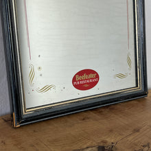 Load image into Gallery viewer, It features an oval logo of the famous pub branding in a matt red, an intricate Victorian-style gold border, and a darker wooden frame.