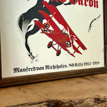 Load image into Gallery viewer, Vintage Red Baron plane mirror featuring vivid picture of the plane in bright colours with a battle scene over the mirror and bold font describing the pilot name and the dates, more historical detail about the piece further down.