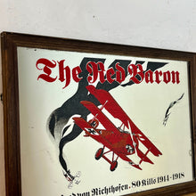 Load image into Gallery viewer, Vintage Red Baron plane mirror featuring vivid picture of the plane in bright colours with a battle scene over the mirror and bold font describing the pilot name and the dates, more historical detail about the piece further down.
