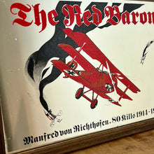 Load image into Gallery viewer, Vintage Red Baron plane mirror featuring vivid picture of the plane in bright colours with a battle scene over the mirror and bold font describing the pilot name and the dates, more historical detail about the piece further down.