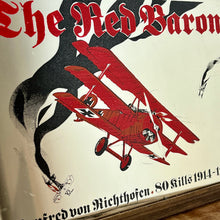 Load image into Gallery viewer, Vintage Red Baron plane mirror featuring vivid picture of the plane in bright colours with a battle scene over the mirror and bold font describing the pilot name and the dates, more historical detail about the piece further down.