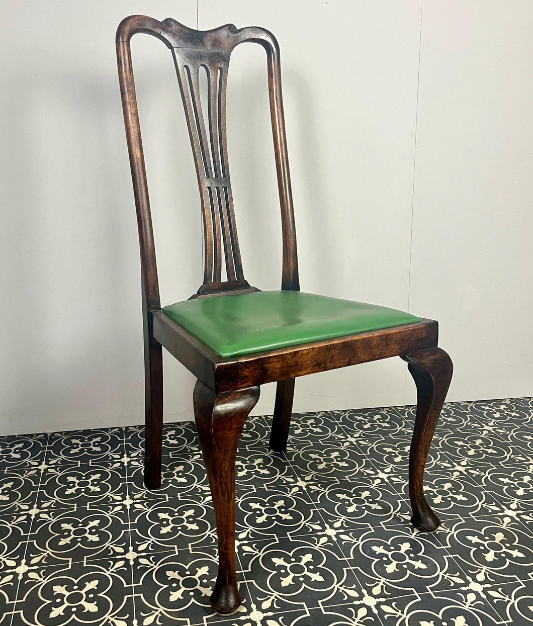 The mahogany chair with shaped backrest has a beautifully shaped finish with a piercing splat with a harp design, drop-in seats in a nice green tone leather type material, with one minor scuff and the padding, had fallen it, on lovely cabriole legs