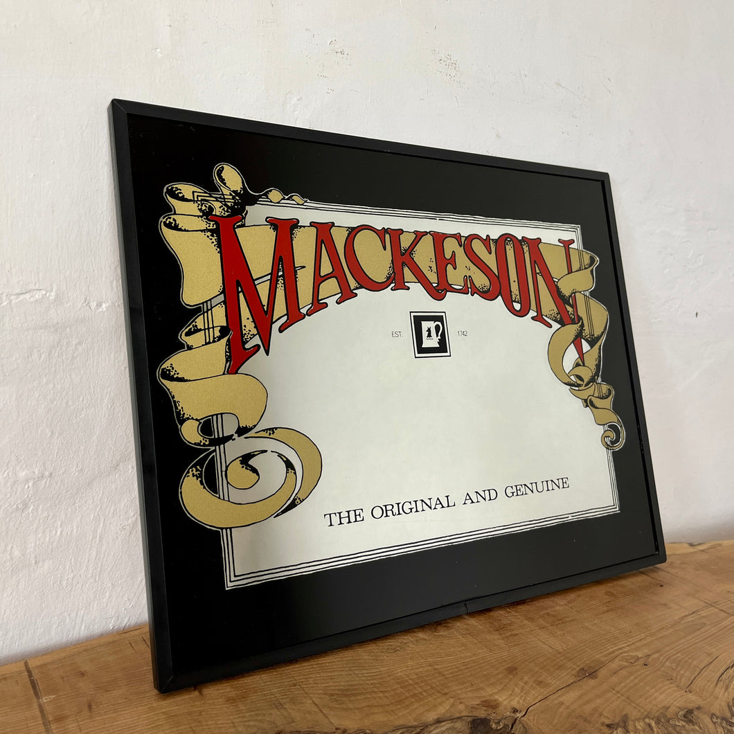 The mirror boasts a striking design of the famous brewery, featuring a bold and vivid red fold, an intricate picture, and a thick black border. The iconic quote, the original and genuine, adds to its appeal.