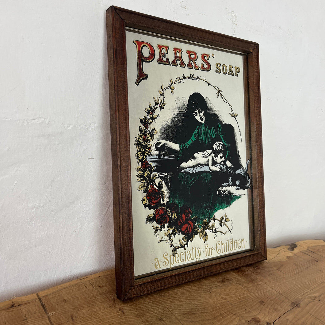 An Appealing Vintage mid-century Pears Soap Advertising mirror featuring an antique Victorian baby changing scene with intricate rose floral border and stand-out fonts.