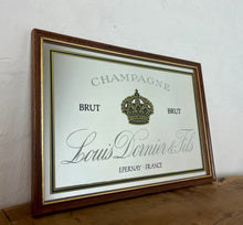Load image into Gallery viewer, Louis Doinier and Fils Champagne brut advertising mirror in an elegant design of the famous French champagne producer with multiple classy fonts on the branding with the intricate gold crown logo and a sleek gold and black border.
