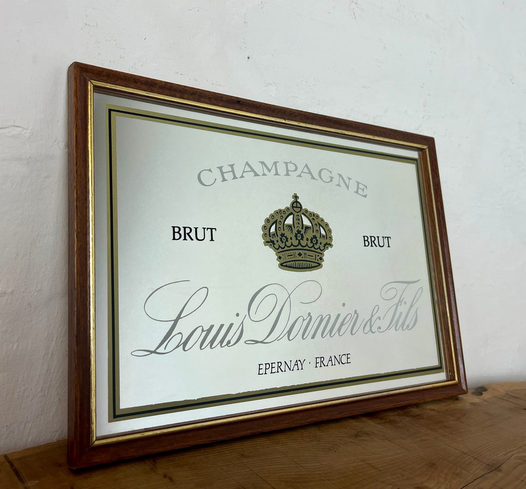 Louis Doinier and Fils Champagne brut advertising mirror in an elegant design of the famous French champagne producer with multiple classy fonts on the branding with the intricate gold crown logo and a sleek gold and black border.