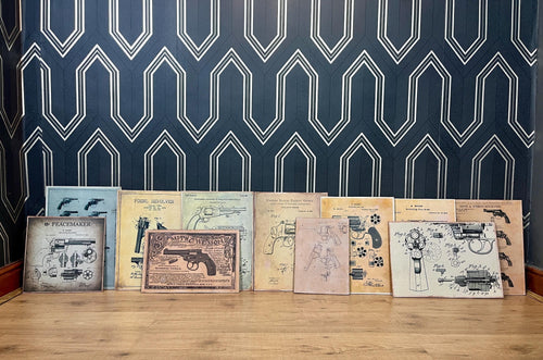 A selection of eleven gun and revolver art pictures with stunning deals created in a vintage style and printed on old wooden sheets likely to be developed in the 90s