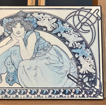 Load image into Gallery viewer, This vintage art nouveau wooden wall plaque, with a blue effect, is a unique piece of art. It features an elegant lady wearing an attractive headdress, her hair tied up, and a selection of glamorous clothing.
