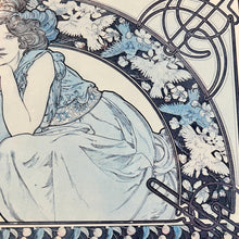 Load image into Gallery viewer, This vintage art nouveau wooden wall plaque, with a blue effect, is a unique piece of art. It features an elegant lady wearing an attractive headdress, her hair tied up, and a selection of glamorous clothing.
