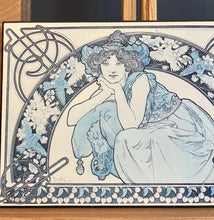 Load image into Gallery viewer, This vintage art nouveau wooden wall plaque, with a blue effect, is a unique piece of art. It features an elegant lady wearing an attractive headdress, her hair tied up, and a selection of glamorous clothing.
