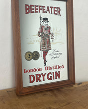 Load image into Gallery viewer, vintage Gordon’s London dry gin mirror, an advertising collectable for wines and spirits. The stunning design features the famous London gin brand in vivid red fonts, a vibrant gold background, and a picture of the familiar logo
