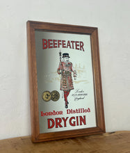 Load image into Gallery viewer, Vintage Beefeater London dry gin mirror, an advertising collectable for wines and spirits. The stunning design features the famous London gin brand in vivid red fonts, a vibrant gold background, and a picture of the familiar logo
