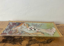 Load image into Gallery viewer, ncredible, vibrant Mucha spring art nouveau ring dish or decorative dish featuring a glamorous lady with a vivid, colourful tree and cherry blossom background. She is wearing a beautiful white dress and a floral headband, playing her harp
