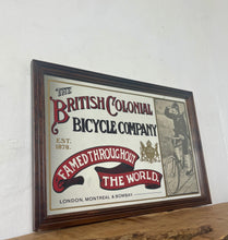 Load image into Gallery viewer, Amazing vintage British Colonial Bicycle Company advertising mirror showing fabulous font in vivid colour on the side in a stunning picture or a policeman with him moustache on an antique bike with the background a far off backdrop
