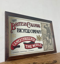 Load image into Gallery viewer, Amazing vintage British Colonial Bicycle Company advertising mirror showing fabulous font in vivid colour on the side in a stunning picture or a policeman with him moustache on an antique bike with the background a far off backdrop
