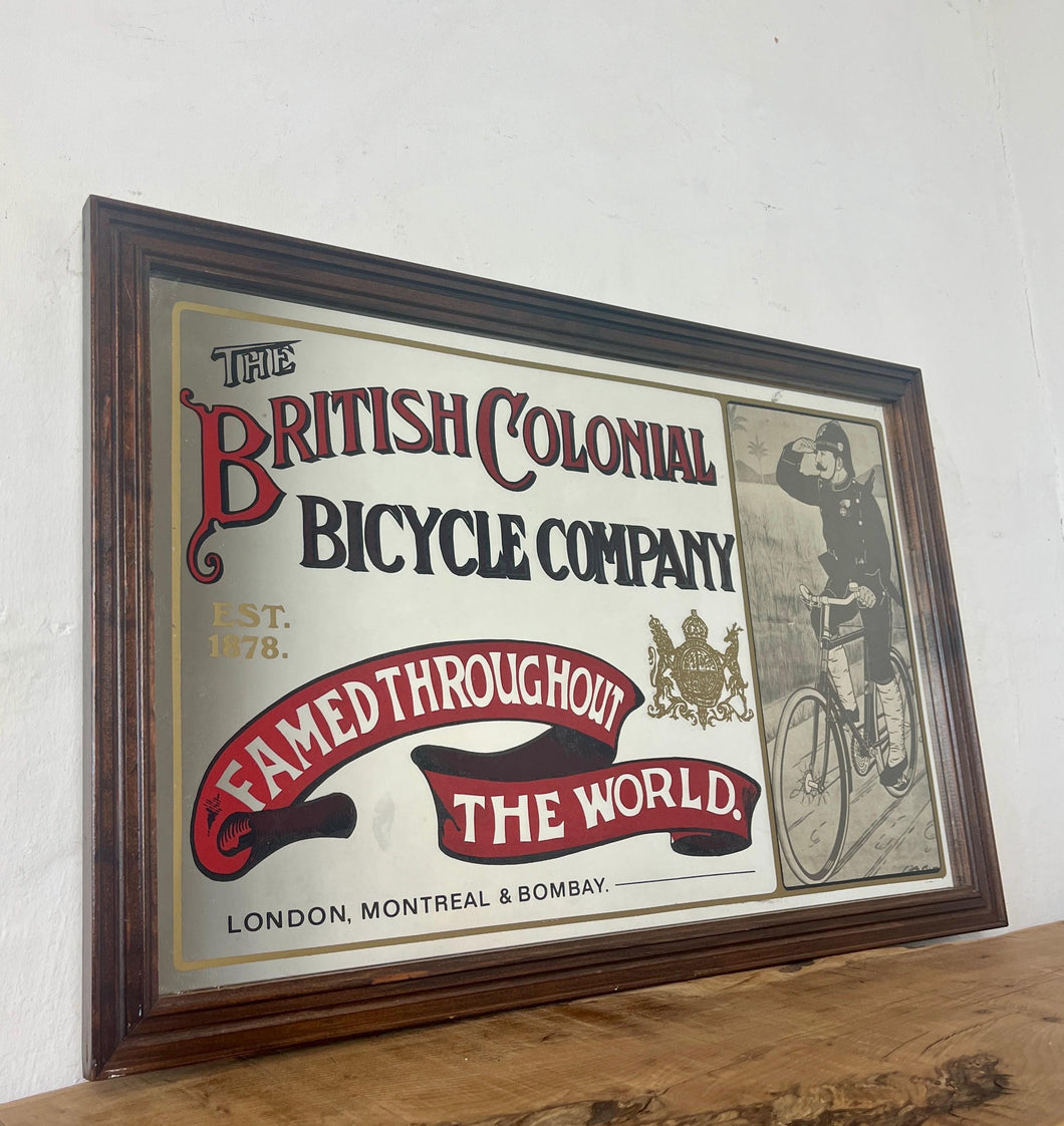 Amazing vintage British Colonial Bicycle Company advertising mirror showing fabulous font in vivid colour on the side in a stunning picture or a policeman with him moustache on an antique bike with the background a far off backdrop