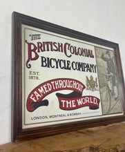 Load image into Gallery viewer, Amazing vintage British Colonial Bicycle Company advertising mirror showing fabulous font in vivid colour on the side in a stunning picture or a policeman with him moustache on an antique bike with the background a far off backdrop
