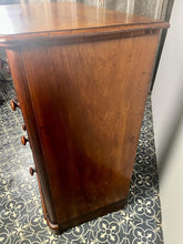 Load image into Gallery viewer, Good quality large antique Victorian mahogany chest of drawers with curved corners, turned bun handles, and a part missing underneath one handle. The bottom drawer is deep and has the plinth attached.
