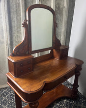 Load image into Gallery viewer, Crafted from elegant quality mahogany, it has a shaped mirror set within a frame. Stunning carved and scrolled supports lead to a pair of two small drawers. It has a moulded edge to the shaped dressing table top with one central drawer.
