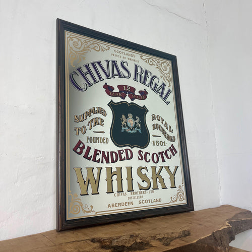 This stunning vintage mirror of Chivas Regal scotch whisky is a collectible item from the Aberdeen, Scotland distillery. It can be used as an advertising piece or wall art in a bar or pub.