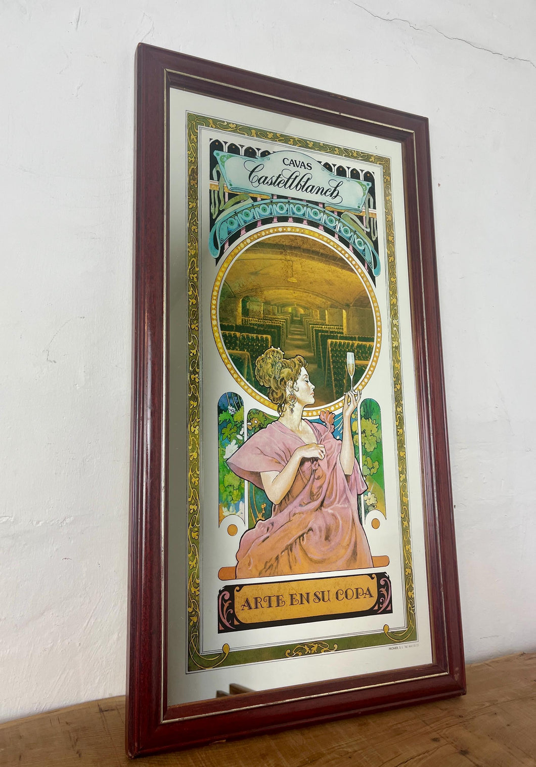 This beautiful art deco vintage mirror, made around 1960, is a stunning collectible piece advertising the famous Spanish Wine Cavas Castellblanch.