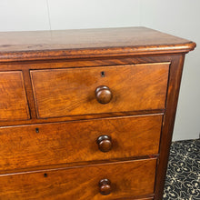 Load image into Gallery viewer, Good quality large antique Victorian mahogany chest of drawers with curved corners, turned bun handles, and a part missing underneath one handle. The bottom drawer is deep and has the plinth attached.
