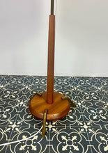 Load image into Gallery viewer, Vintage Scandinavian designer Teak Floor Lamp. This stunning teak floor lamp features a circular base with stylish brass details paired with a mustard fabric lamp shade. It is perfect as an additional light in your living room or workspace.
