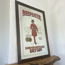Load image into Gallery viewer, The stunning design features the famous London gin brand in vivid red fonts, a vibrant gold background, and a picture of the familiar logo on the King Body Guard of the Yeomen of the Guard (Beefeater).
