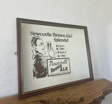 Load image into Gallery viewer, Vibrant Newcastle brown ale mirror with stand out fonts with great picture with a man enjoying his beer, fantastic slogan and interesting information about the prices, with further unique branding information a very stylish piece.

