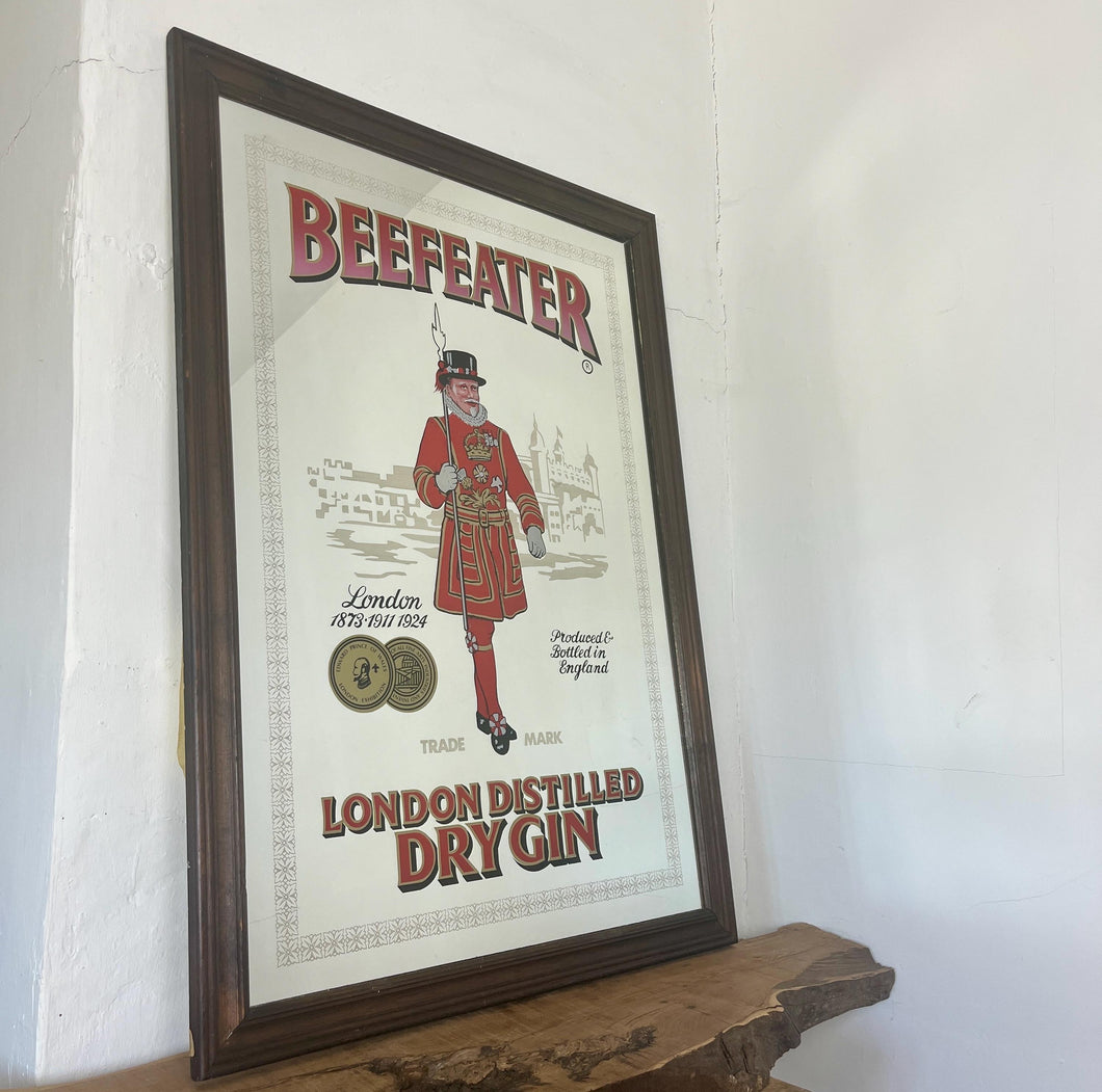 The stunning design features the famous London gin brand in vivid red fonts, a vibrant gold background, and a picture of the familiar logo on the King Body Guard of the Yeomen of the Guard (Beefeater).