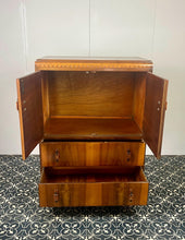Load image into Gallery viewer, This cabinet contains a long cupboard with vivid-tone burr walnut doors on either side and a stunning detailed design. It has two shelves underneath for extra storage, making it the perfect place to store your martini accessories.
