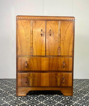 Load image into Gallery viewer, This cabinet contains a long cupboard with vivid-tone burr walnut doors on either side and a stunning detailed design. It has two shelves underneath for extra storage, making it the perfect place to store your martini accessories.
