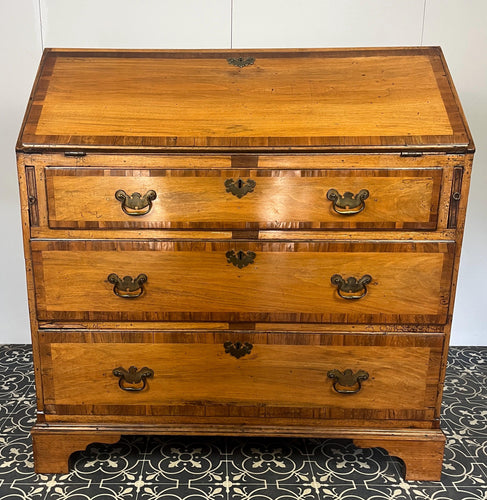 The stunning original George II Bureau, which was written in English circa the mid-18th century, represents the epitome of fine craftsmanship. Featuring camphor wood and rosewood banding, a writing bureau with a perfect leather writing surface.