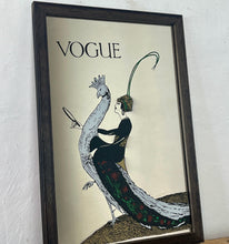 Load image into Gallery viewer, This exquisite vintage item showcases a captivating peacock design that draws inspiration from Vogue&#39;s April 1918 magazine cover. It depicts a sophisticated lady adorned with a fashionable headband, holding a mirror above the Vogue designer logo, all encased within a delicate border.
