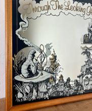 Load image into Gallery viewer, The stunning vintage mirror features intricate designer pictures, including a scene from Alice in Wonderland, showing a selection of characters from the fairytale, with exquisite detail, noir effect, and hints of gold.
