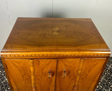 Load image into Gallery viewer, This cabinet contains a long cupboard with vivid-tone burr walnut doors on either side and a stunning detailed design. It has two shelves underneath for extra storage, making it the perfect place to store your martini accessories.
