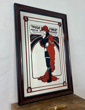 Load image into Gallery viewer, Stunning Mucha mirror featuring vibrant tones featuring a large detailed picture of the figure in orange and black with an intricate pattern border following with the same colours and bold vivid fonts to create a stand out design.
