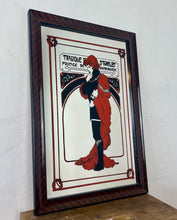 Load image into Gallery viewer, Stunning Mucha mirror featuring vibrant tones featuring a large detailed picture of the figure in orange and black with an intricate pattern border following with the same colours and bold vivid fonts to create a stand out design.
