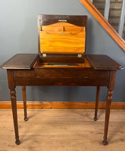Load image into Gallery viewer, This piece&#39;s tidy and neat finish, with its groundbreaking design, incorporates a lifting centre section with a writing surface and letter racking. The side sections have hinged lids that open to further storage compartments. The table is supported on elegant turned legs. This is a great space-saving piece that will suit a traditional home. It is the perfect size for your laptop and a great addition to the space-saving design.
