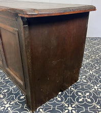 Load image into Gallery viewer, The antique oak coffer is of simple, plain form and has a hinged lid that opens to reveal a spacious interior. The coffer has a three-panel front and is raised on block feet. One of my favourite parts is the back panel that has been crudely chiselled from one section of oak, with an excellent, authentic craftsmanship finish.
